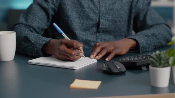 Closeup African American Black Man Hands Taking Notes on Notepad Using a Pen alt