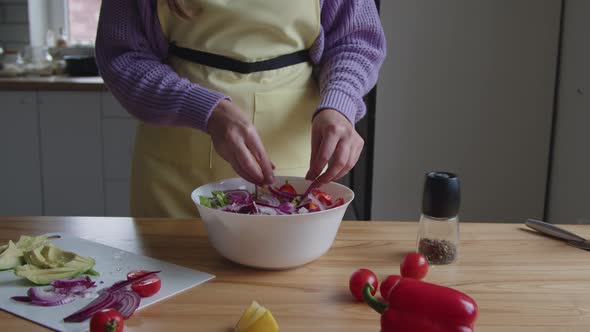 Woman Is Adding Red Onion to Salad