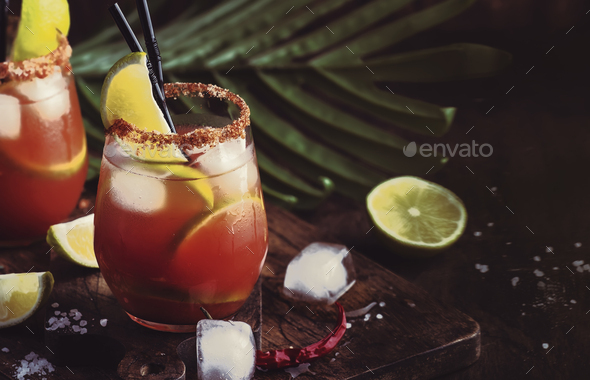 Mexican inspired bloody mary alcoholic cocktail with beer, lime juice, tomato juice - Stock Photo - Images