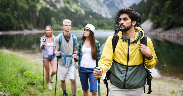 Group of happy hiker friends trekking as part of healthy lifestyle outdoors activity