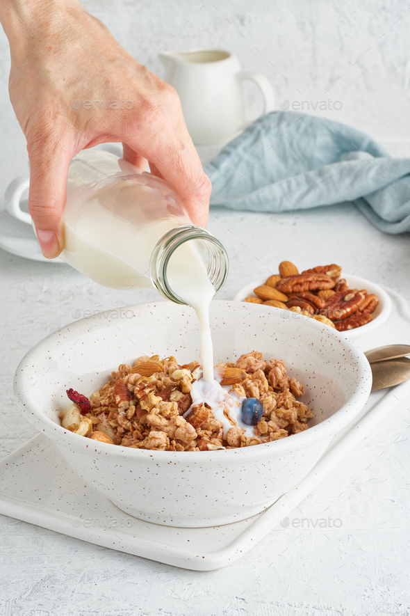 Granola. Breakfast, healthy diet food with oat flakes, nuts, banana - Stock Photo - Images