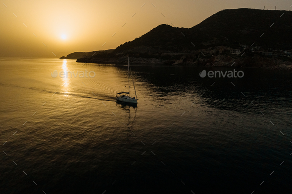 Aerial view of yacht in the sea with beautiful sunrise - Stock Photo - Images