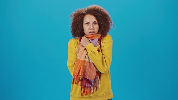 African American Woman Feels Cold Covering with Scarf alt