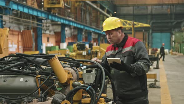 Plant Supervisor With Tablet Checking Equipment alt