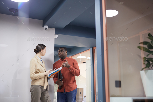 Two Business People Talking in Modern Office Interior - Stock Photo - Images