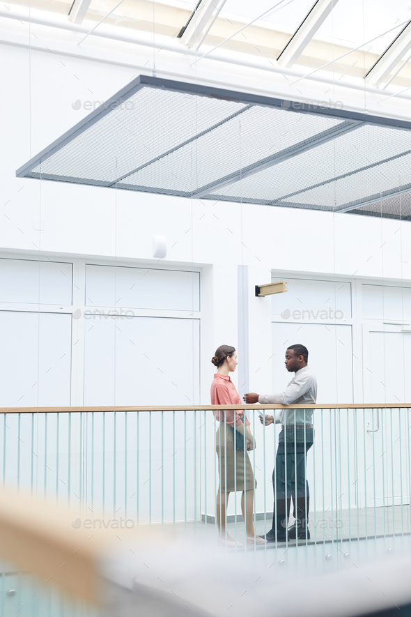Two Contemporary Business People in Office Building Interior - Stock Photo - Images