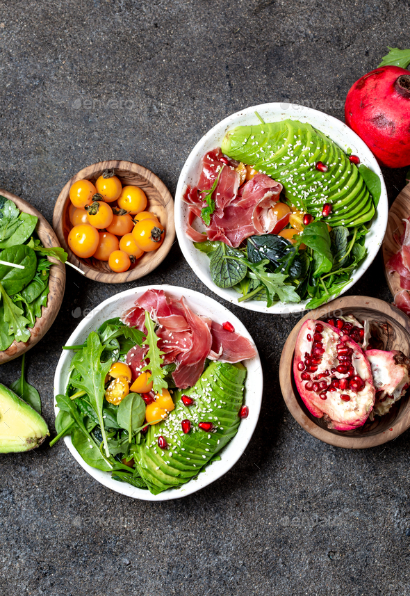Low carbs bowl. Fresh salad with green spinach, rucola, avocado an ham