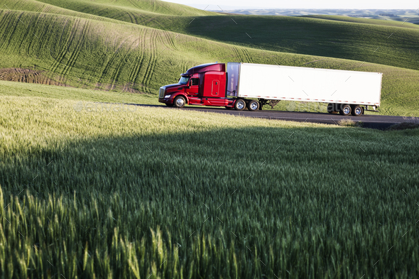 commercial truck driving though wheat fields of eastern Washington, USA ...