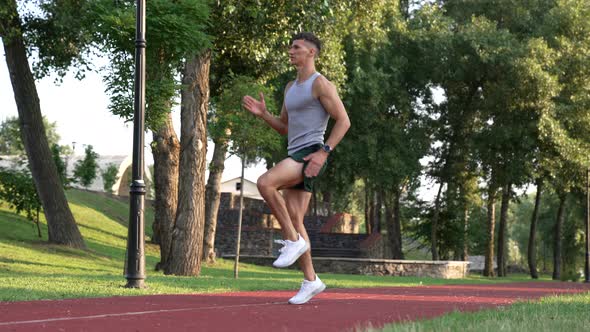 Fitness Trainer Jogging in Place with a High Rise of the Shin Challenge Slow Motion alt