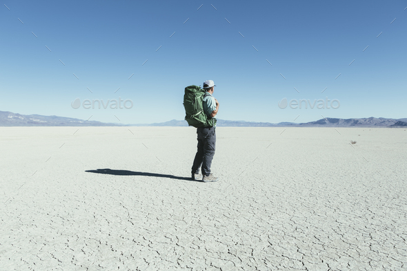 Male backpacker hiking in vast desert, Black Rock Desert, Nevada
