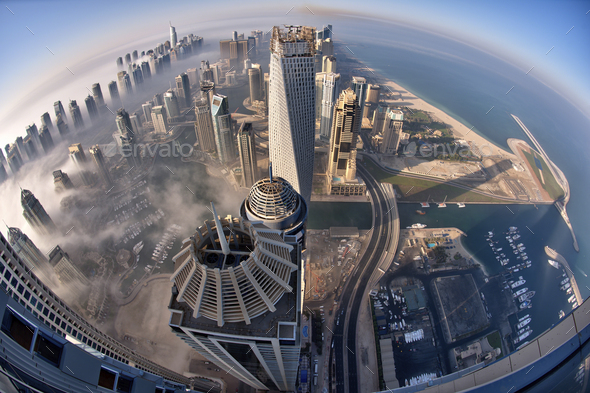 Aerial view of cityscape with skyscrapers above the clouds in Dubai, United Arab Emirates. - Stock Photo - Images