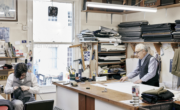 Father and son making suits in family-run tailor business