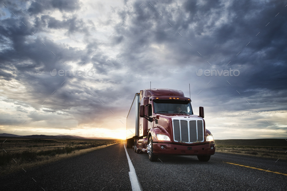 3/4 front view of a  commercial truck on the road at sunset  in eastern Washington, USA - Stock Photo - Images