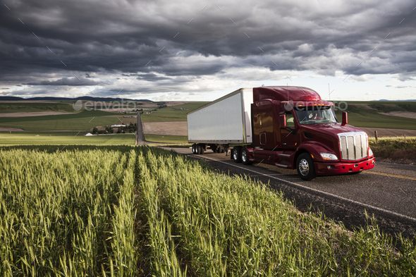 commercial truck driving though wheat fields of eastern Washington, USA at sunset. - Stock Photo - Images