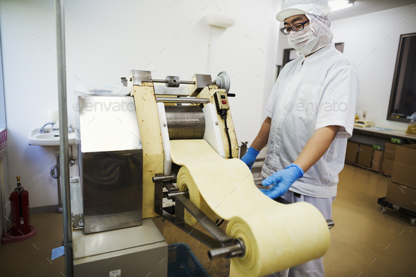 Worker in a factory producing Soba noodles - Stock Photo - Images