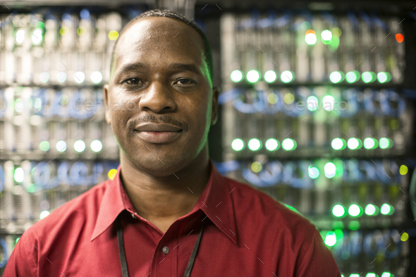 Black man technician in a computer server farm. - Stock Photo - Images