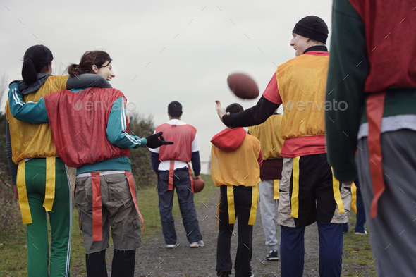 View from behind of a group of friends getting ready for an American Flag Football game.