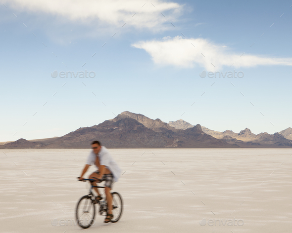 Man bicycling on Bonneville Salt Flats during Speed Week - Stock Photo - Images
