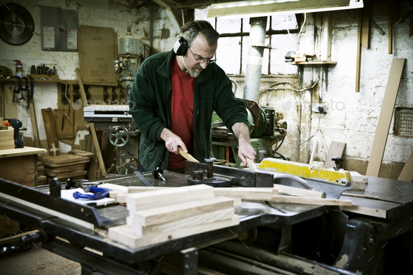 A man working in a furniture maker\'s workshop.