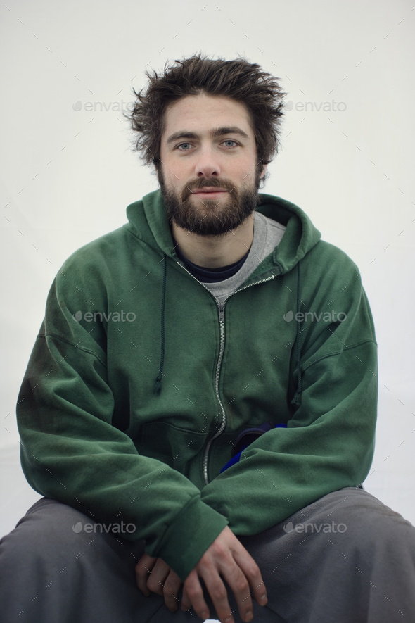 Portrait of a caucasian man in jogging pants and a sweatshirt hoodie.