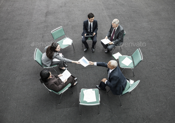 Mixed race group of business people in an informal team building meeting.
