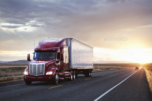 3/4 front view of a commercial truck on the road at sunset  in eastern Washington, USA - Stock Photo - Images