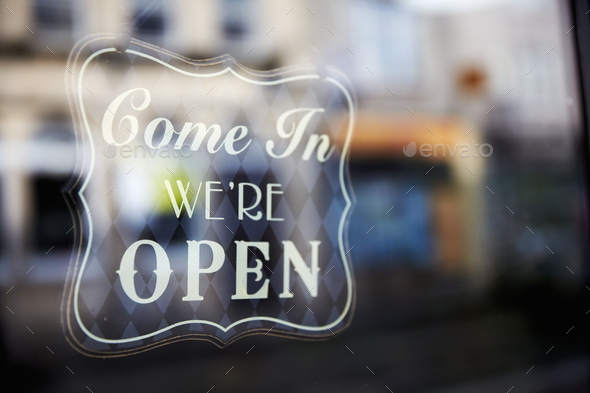 A sign etched in glass, Come In, We\'re Open.