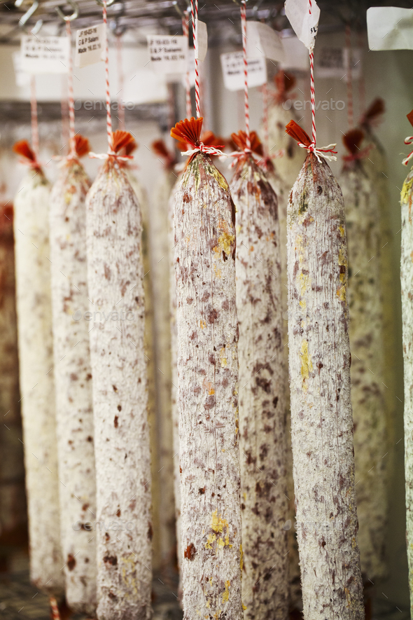 Close up of Chorizo sausages hanging from hooks in a charcuterie. Stock  Photo by Mint_Images