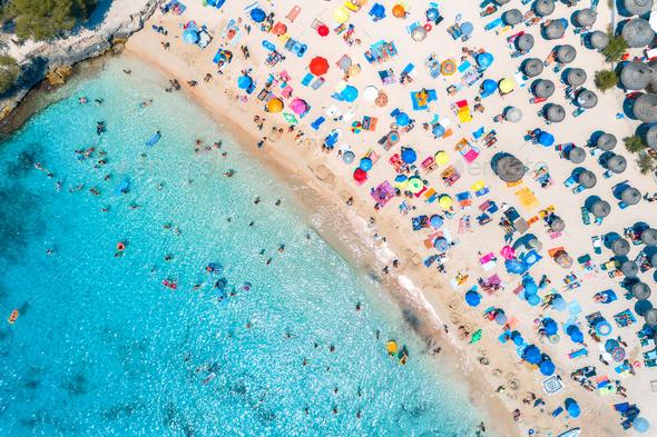 Aerial view of sandy beach with colorful umbrellas - Stock Photo - Images