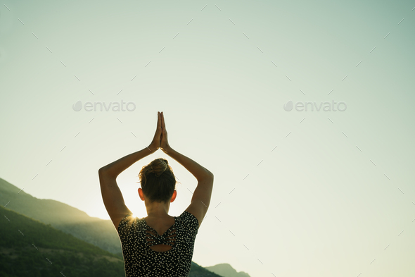 Young woman doing yoga workout at sunrise - Stock Photo - Images