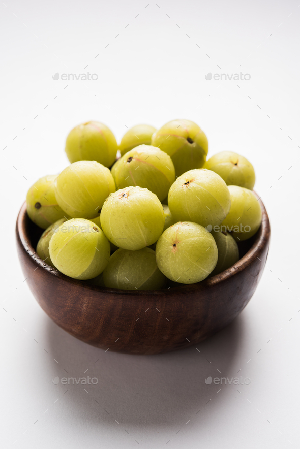 Close Up Of Indian Gooseberry Or Amla With Turmeric And Lemon Juice On  Wooden Surface In A Glass Bowl To Get Rid Of Blemishes,acne And Pimples.  Stock Photo, Picture and Royalty Free