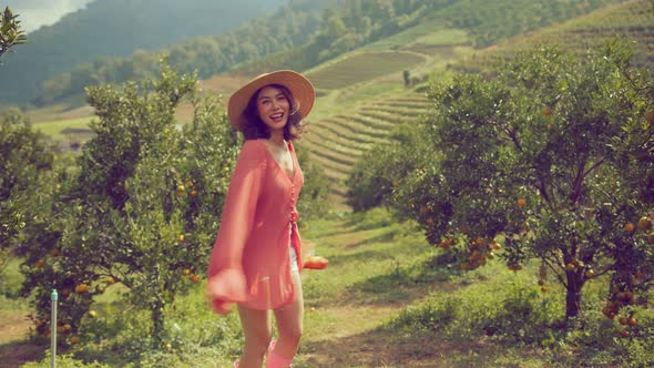 young beautiful attractive asian woman wearing casual colorful dress alt