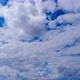 Layered Clouds Move in Blue Sky Under Bright Sun Fluffy Cloudscape Timelapse - VideoHive Item for Sale