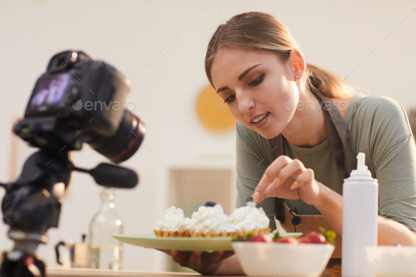 Woman shooting the process of decorating the cakes