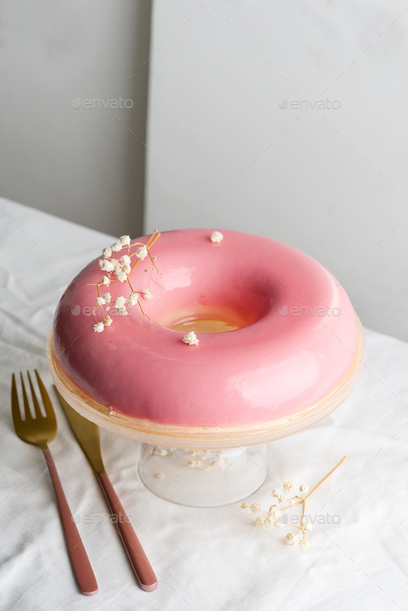 Holiday homemade glazed strawberry cake on a glass plate decorated eco plant on a cloth table - Stock Photo - Images