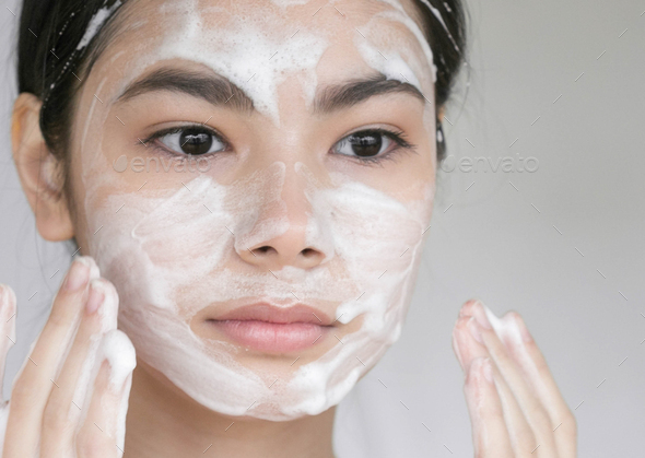Soap face Young beautiful woman washing her face