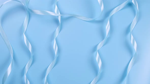 Blue Background with Satin Ribbons Concept of Boy and Newborn Birthday Celebration or Blue Party