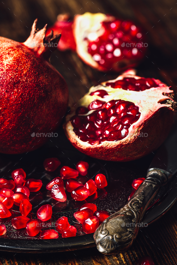 Ruby Pomegranate with Seeds and Knife - Stock Photo - Images