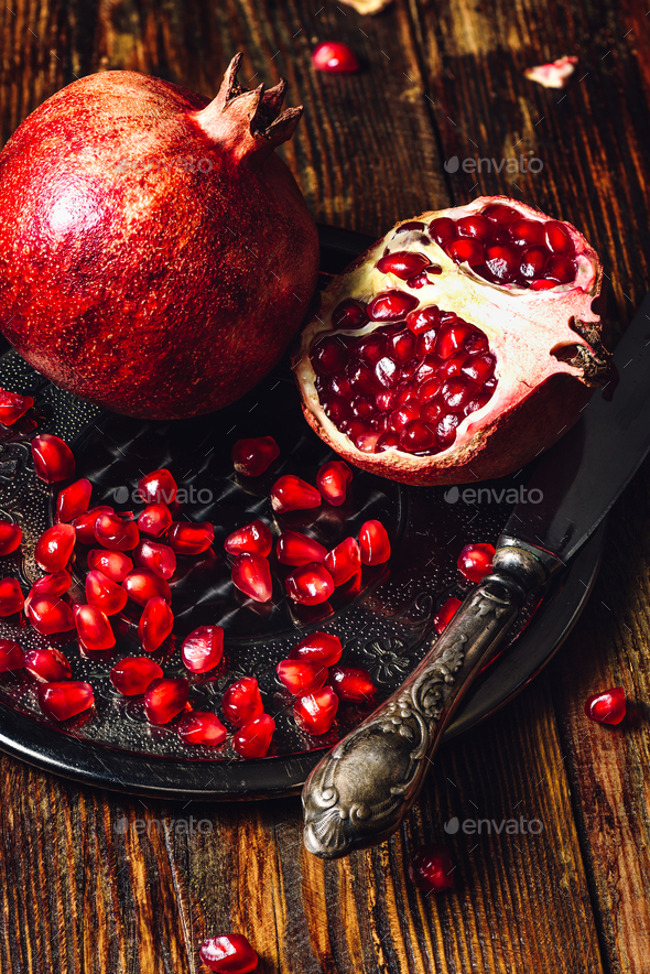 Pomegranates with Seeds and Knife - Stock Photo - Images