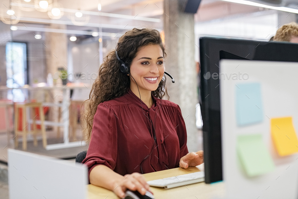 Happy smiling woman working in call center - Stock Photo - Images