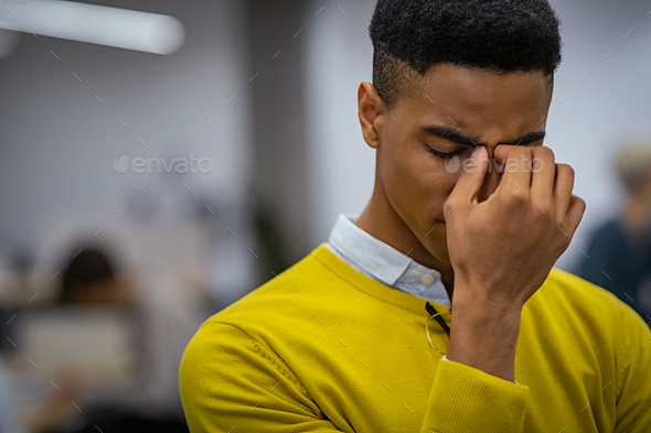 Stressed young man with migraine - Stock Photo - Images