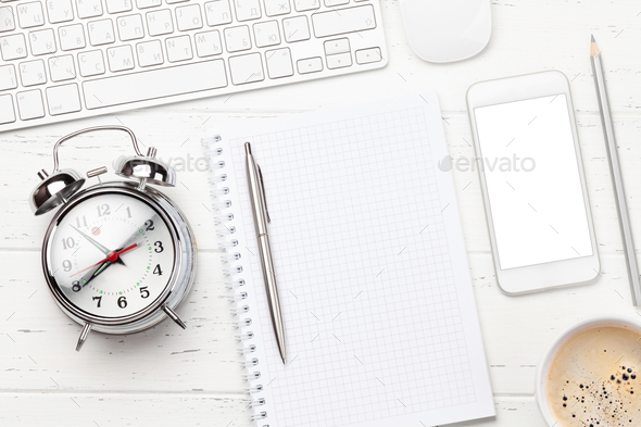 Workplace with smartphone, supplies and alarm clock - Stock Photo - Images