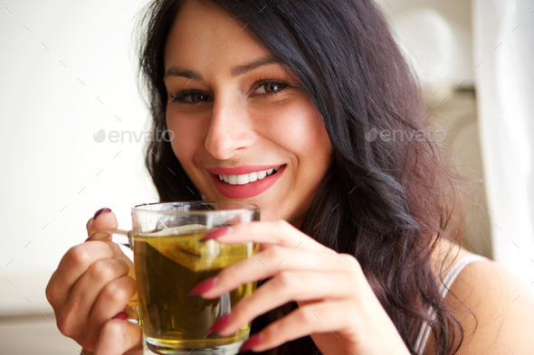 happy woman inside cozy apartment with hot tea