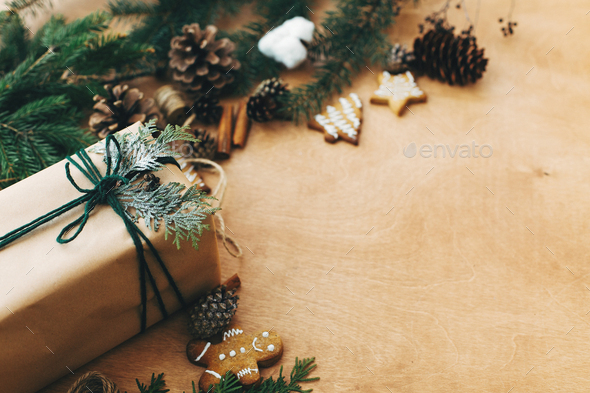Stylish rustic christmas gifts box with cedar branch on rural wooden table  Stock Photo by Sonyachny