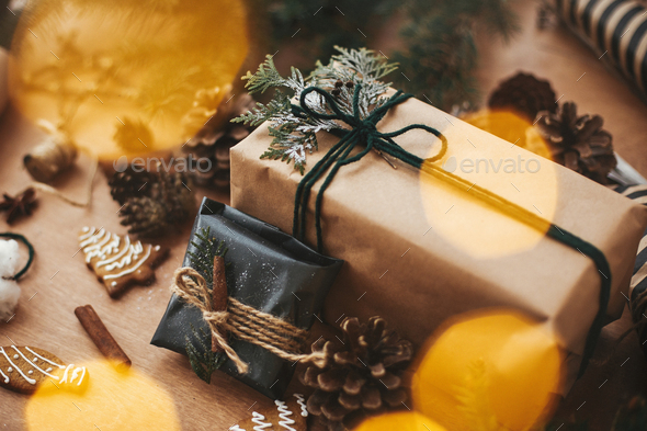 Stylish rustic christmas gifts box with cedar branch on rural wooden table  Stock Photo by Sonyachny