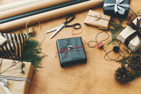 Stylish christmas gift box in black paper. Season's greetings - Stock Photo - Images