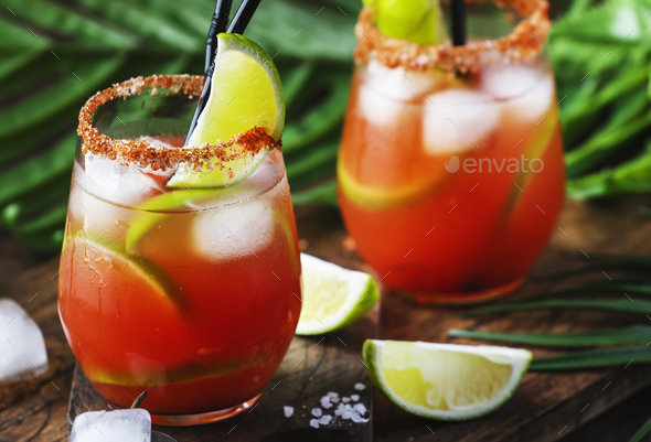 bloody mary alcoholic cocktail with beer, lime juice, tomato juice, spicy sauce and spices - Stock Photo - Images