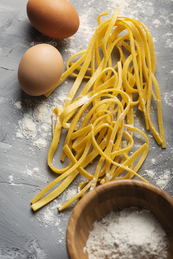 Traditional italian raw pasta with eggs Stock Photo by OxanaDenezhkina