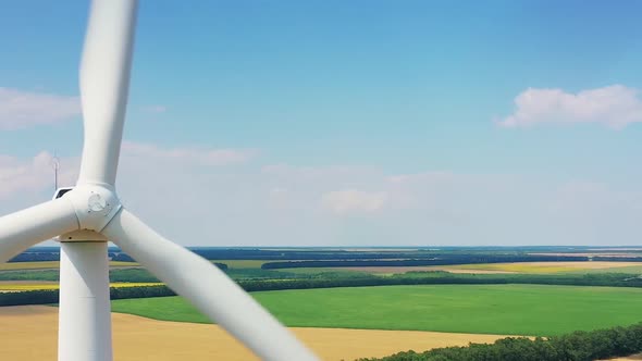 Wind Turbines And Agricultural Fields On A Summer Landscape