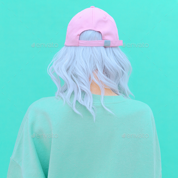 Aesthetic girl in stylish accessories b-boy cap. Fresh pastel colours monochrome fashion design